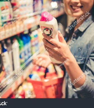 stock-photo-beautiful-young-woman-is-choosing-household-products-and-smiling-while-doing-shopping-at-the-604022768