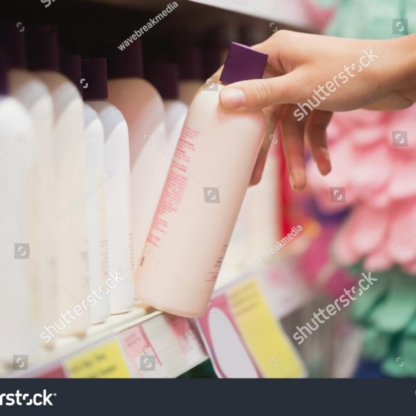 stock-photo-focus-on-hands-picking-shampoo-in-supermarket-573197266