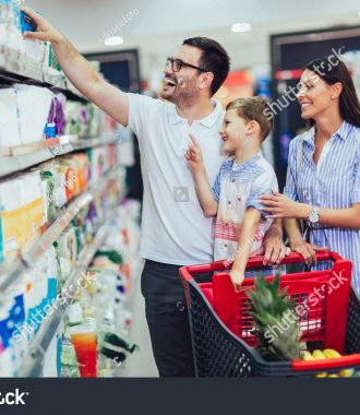 stock-photo-happy-family-with-child-and-shopping-cart-buying-food-at-grocery-store-or-supermarket-1448281628